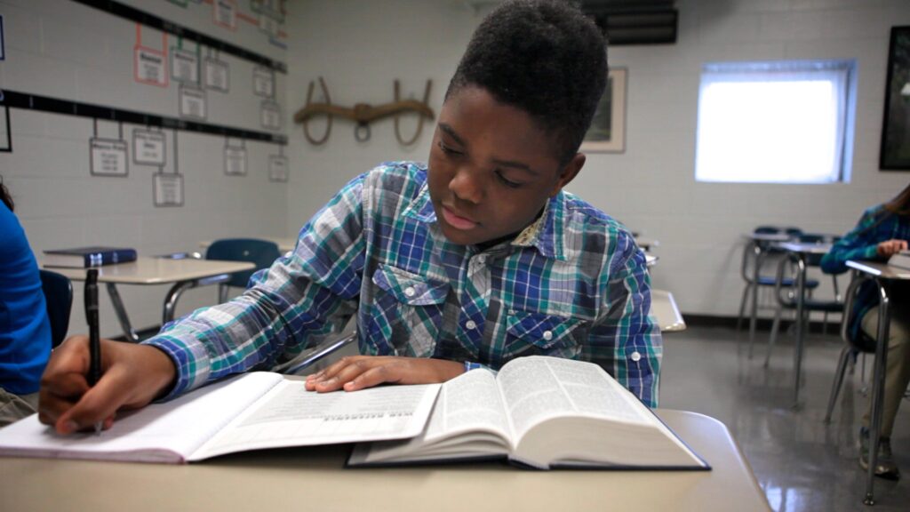 a student eagerly studying his bible