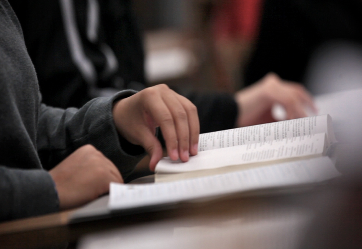 a hand  flipping a bible page